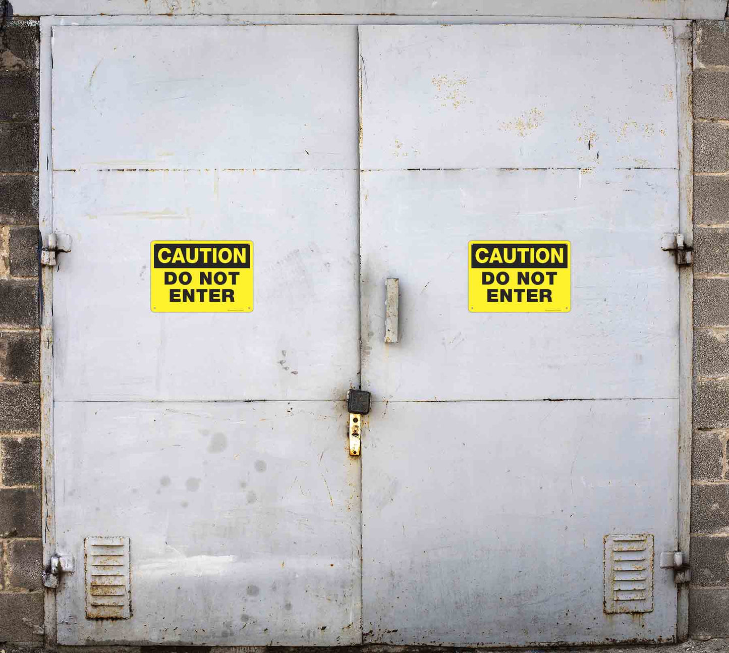 Caution Do Not Enter aluminum sign and vinyl sticker sign installed on metal doors.