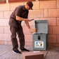 Delivery being placed in delivery box with package delivery sticker sign on the box.